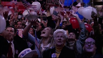 Movie still from “The Manchurian Candidate” (2004), directed by Jonathan Demme – A group of people in a crowd at a political event; Medium shot, High angle