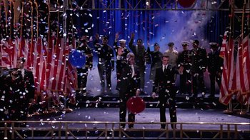 Movie still from “The Manchurian Candidate” (2004), directed by Jonathan Demme – A group of men standing on top of a stage under confetti; Wide shot, Low angle