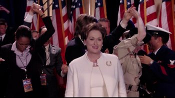 Movie still from “The Manchurian Candidate” (2004), directed by Jonathan Demme – A group of people standing in front of american flags; Medium shot, Low angle