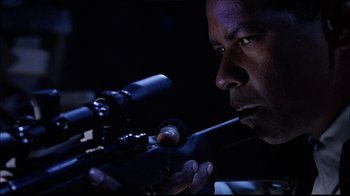 Movie still from “The Manchurian Candidate” (2004), directed by Jonathan Demme – A man with a rifle looking into the distance; Close Up shot, Low angle