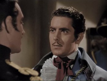 Movie still from “The Mark of Zorro” (1940), directed by Rouben Mamoulian – A person wearing a suit and tie; Close Up shot, Over the shoulder angle
