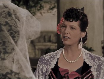 Movie still from “The Mark of Zorro” (1940), directed by Rouben Mamoulian – A woman wearing a dress with a flower in her hair; Close Up shot, Over the shoulder angle