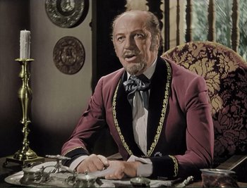 Movie still from “The Mark of Zorro” (1940), directed by Rouben Mamoulian – An older man sitting at a table wearing a suit and bow tie; Medium shot, Low angle