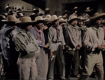 Movie still from “The Mark of Zorro” (1940), directed by Rouben Mamoulian – A group of men standing next to each other wearing hats; Wide shot, High angle