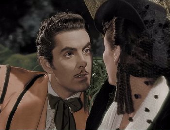 Movie still from “The Mark of Zorro” (1940), directed by Rouben Mamoulian – A man and a woman looking at each other in front of an umbrella; Close Up shot, Over the shoulder angle