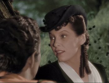 Movie still from “The Mark of Zorro” (1940), directed by Rouben Mamoulian – A woman wearing a black hat talking to another woman; Close Up shot, Over the shoulder angle