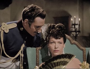 Movie still from “The Mark of Zorro” (1940), directed by Rouben Mamoulian – A man and a woman sitting in a chair; Medium shot, Over the shoulder angle