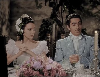 Movie still from “The Mark of Zorro” (1940), directed by Rouben Mamoulian – A man and a woman sitting at a dinner table; Medium shot, High angle