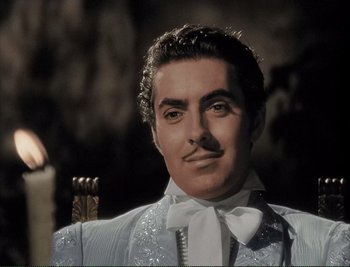 Movie still from “The Mark of Zorro” (1940), directed by Rouben Mamoulian – A person wearing a suit and bow tie; Close Up shot, Low angle