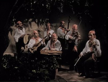 Movie still from “The Mark of Zorro” (1940), directed by Rouben Mamoulian – A group of men in white shirts and ties playing musical instruments; Wide shot, High angle