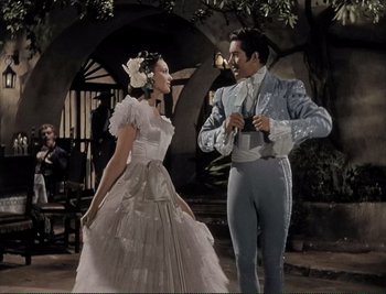 Movie still from “The Mark of Zorro” (1940), directed by Rouben Mamoulian – A man and a woman dressed in old fashion clothing; Wide shot, Low angle