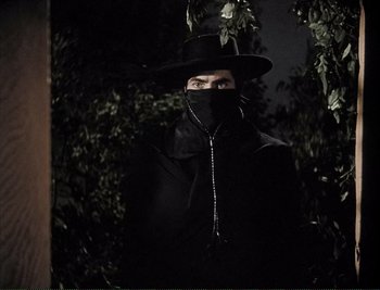 Movie still from “The Mark of Zorro” (1940), directed by Rouben Mamoulian – A man wearing a black hat and a black coat; Medium shot, Low angle