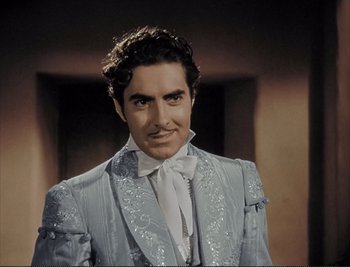 Movie still from “The Mark of Zorro” (1940), directed by Rouben Mamoulian – A man in a suit and tie standing in front of a wall; Medium shot, Low angle