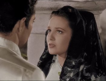 Movie still from “The Mark of Zorro” (1940), directed by Rouben Mamoulian – A woman in a black veil looking at a man in a white shirt; Close Up shot, Over the shoulder angle