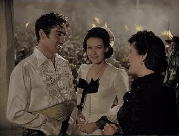 Movie still from “The Mark of Zorro” (1940), directed by Rouben Mamoulian – Two women and a man are talking to each other; Medium shot, High angle