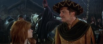 Movie still from “The Masque of the Red Death” (1964), directed by Roger Corman – A man and a woman in medieval garb in front of horses; Medium shot, Over the shoulder angle