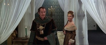 Movie still from “The Masque of the Red Death” (1964), directed by Roger Corman – A man and a woman dressed in medieval clothing; Medium shot, Low angle
