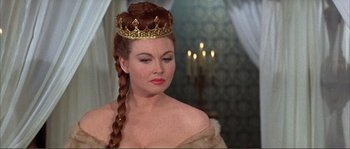 Movie still from “The Masque of the Red Death” (1964), directed by Roger Corman – A woman with a crown on her head; Close Up shot, Over the shoulder angle