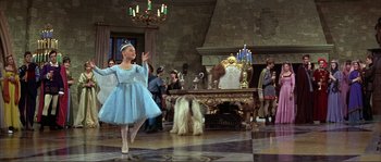 Movie still from “The Masque of the Red Death” (1964), directed by Roger Corman – A girl in a blue dress and a white dog; Wide shot, Low angle