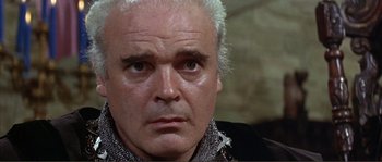 Movie still from “The Masque of the Red Death” (1964), directed by Roger Corman – An older man with white hair looking at the camera; Close Up shot, Low angle