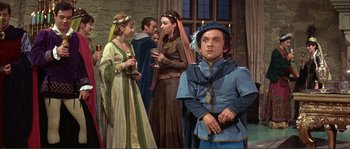 Movie still from “The Masque of the Red Death” (1964), directed by Roger Corman – A group of people standing in a room; Medium shot, High angle