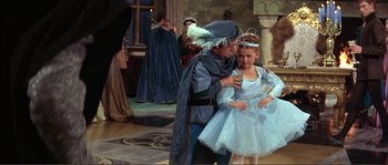 Movie still from “The Masque of the Red Death” (1964), directed by Roger Corman – A man and a little girl dressed as a fairy and prince; Medium shot, High angle