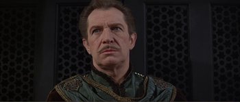 Movie still from “The Masque of the Red Death” (1964), directed by Roger Corman – A man that is wearing a green shirt; Close Up shot, Low angle