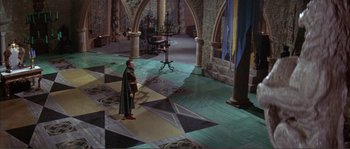 Movie still from “The Masque of the Red Death” (1964), directed by Roger Corman – A man dressed in medieval clothing stands in an ornate room; Extreme Wide shot, High angle