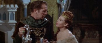 Movie still from “The Masque of the Red Death” (1964), directed by Roger Corman – A man and a woman wearing a crown; Medium shot, Over the shoulder angle