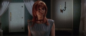 Movie still from “The Masque of the Red Death” (1964), directed by Roger Corman – A woman with red hair wearing a silver dress; Close Up shot, Low angle