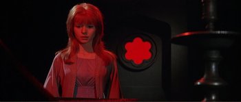 Movie still from “The Masque of the Red Death” (1964), directed by Roger Corman – A woman with red hair standing in front of a wall; Medium shot, Low angle