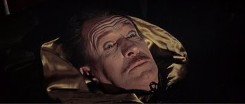 Movie still from “The Masque of the Red Death” (1964), directed by Roger Corman – A man's face in the dark; Close Up shot, Low angle