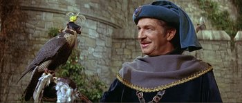 Movie still from “The Masque of the Red Death” (1964), directed by Roger Corman – A man wearing a hat and holding a bird in his hand; Close Up shot, Over the shoulder angle