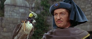 Movie still from “The Masque of the Red Death” (1964), directed by Roger Corman – A person with a bird on his shoulder; Close Up shot, Over the shoulder angle