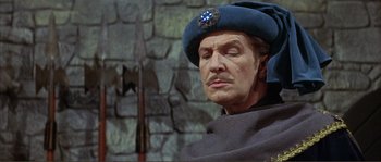 Movie still from “The Masque of the Red Death” (1964), directed by Roger Corman – A person wearing a hat; Close Up shot, Low angle