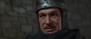 Movie still from “The Masque of the Red Death” (1964), directed by Roger Corman – A person wearing a helmet; Close Up shot, Low angle