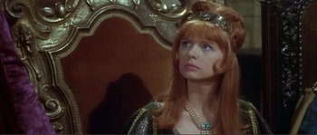 Movie still from “The Masque of the Red Death” (1964), directed by Roger Corman – A woman with red hair wearing a crown and pearls; Close Up shot, Over the shoulder angle
