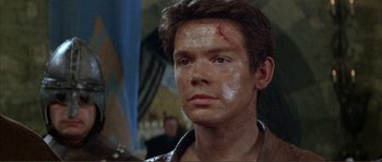 Movie still from “The Masque of the Red Death” (1964), directed by Roger Corman – A person with a scar on his face; Close Up shot, Over the shoulder angle