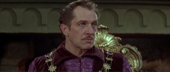 Movie still from “The Masque of the Red Death” (1964), directed by Roger Corman – A person wearing a suit and tie; Close Up shot, Low angle