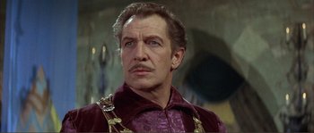 Movie still from “The Masque of the Red Death” (1964), directed by Roger Corman – A person wearing a suit and a necklace; Close Up shot, Low angle