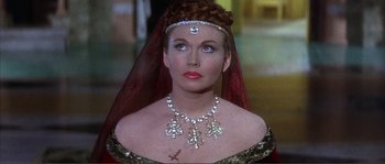 Movie still from “The Masque of the Red Death” (1964), directed by Roger Corman – A woman wearing a necklace and a veil; Close Up shot, Over the shoulder angle
