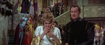 Movie still from “The Masque of the Red Death” (1964), directed by Roger Corman – A woman in a white dress and a man in a black suit; Medium shot, High angle