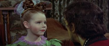 Movie still from “The Masque of the Red Death” (1964), directed by Roger Corman – A little girl and a man are talking to each other; Close Up shot, Over the shoulder angle
