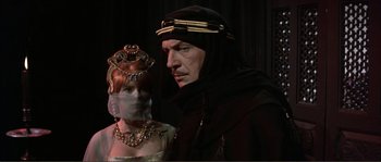 Movie still from “The Masque of the Red Death” (1964), directed by Roger Corman – A man and a woman dressed in medieval clothing; Medium shot, Over the shoulder angle
