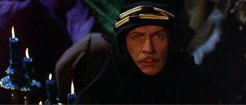 Movie still from “The Masque of the Red Death” (1964), directed by Roger Corman – A person wearing a headdress; Close Up shot, High angle