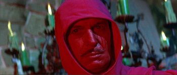 Movie still from “The Masque of the Red Death” (1964), directed by Roger Corman – A person wearing a red hooded jacket; Close Up shot, Low angle