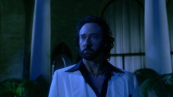 Movie still from “The Master of Disguise” (2002), directed by Perry Andelin Blake – A man with long hair and a beard wearing a white jacket; Close Up shot, Low angle