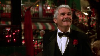 Movie still from “The Master of Disguise” (2002), directed by Perry Andelin Blake – An older man wearing a tuxedo and a bow tie; Close Up shot, Low angle