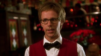 Movie still from “The Master of Disguise” (2002), directed by Perry Andelin Blake – A man wearing a red vest and a bow tie; Close Up shot, Over the shoulder angle