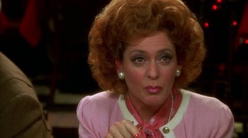 Movie still from “The Master of Disguise” (2002), directed by Perry Andelin Blake – A person with curly hair wearing a pink jacket; Close Up shot, Over the shoulder angle